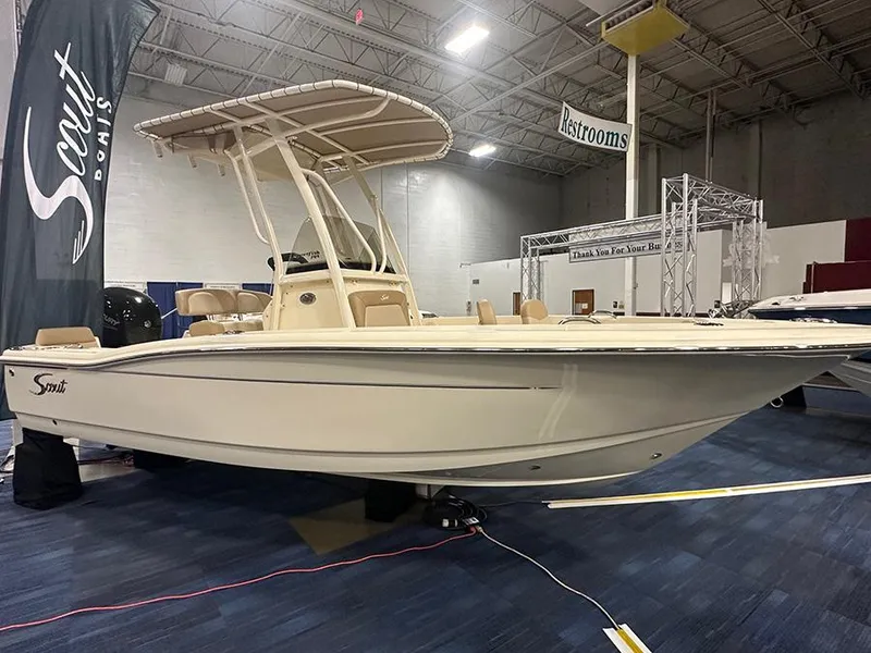 The Image of 2024 Scout 195 Sportfish boat displayed indoors at a showroom. - 0