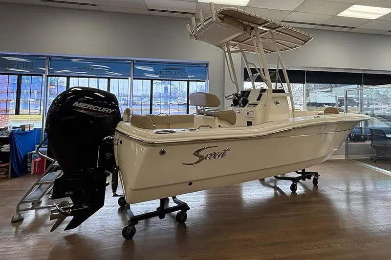 Slide: The Image of 2024 Scout 195 Sportfish boat with 150 HP engine displayed indoors. - 10