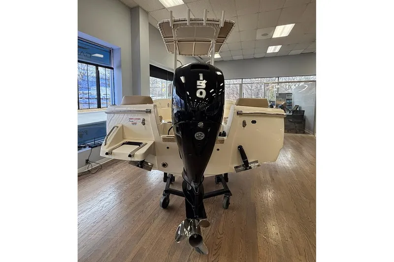 Slide: The Image of 2024 Scout 195 Sportfish boat interior with helm and seating in showroom. - 11