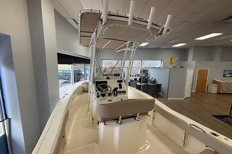 Slide: The Image of 2024 Scout 195 Sportfish boat dashboard with steering wheel and controls. - 12