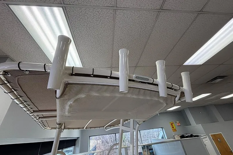 Slide: The Image of 2024 Scout 195 Sportfish boat interior with steering wheel and seating in showroom. - 16