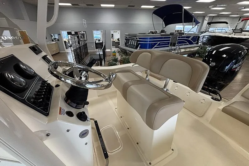 Slide: The Image of 2024 Scout 195 Sportfish boat interior with open door revealing compact toilet. - 17