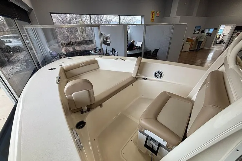 Slide: The Image of 2024 Scout 195 Sportfish boat interior with beige seating and stainless steel handles. - 19