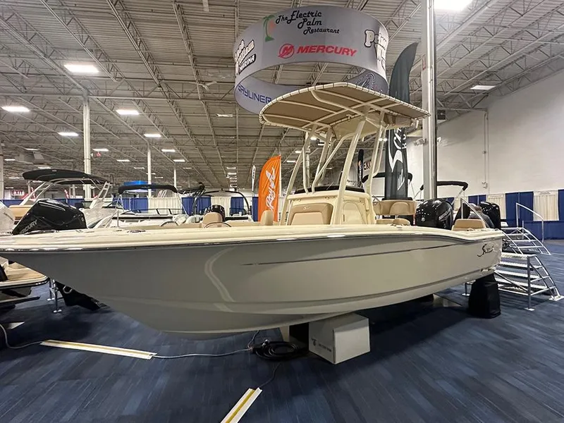 Slide: The Image of 2024 Scout 195 Sportfish boat displayed at indoor boat show. - 2