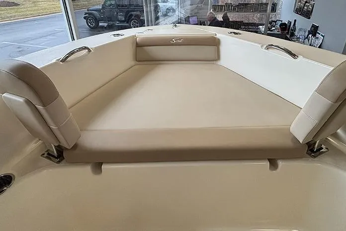 Slide: The Image of 2024 Scout 195 Sportfish boat interior with seating and cooler, displayed indoors. - 20