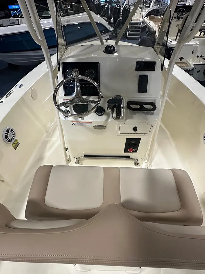 Slide: The Image of 2024 Scout 195 Sportfish boat interior with steering console and seating. - 4