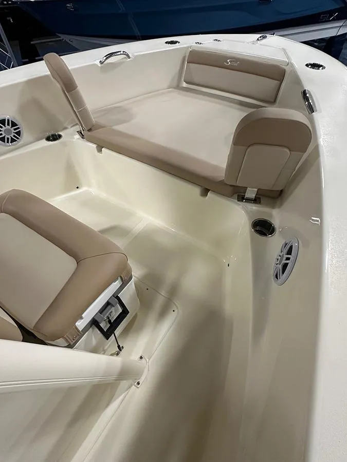 Slide: The Image of 2024 Scout 195 Sportfish boat interior with beige seating and modern design. - 8
