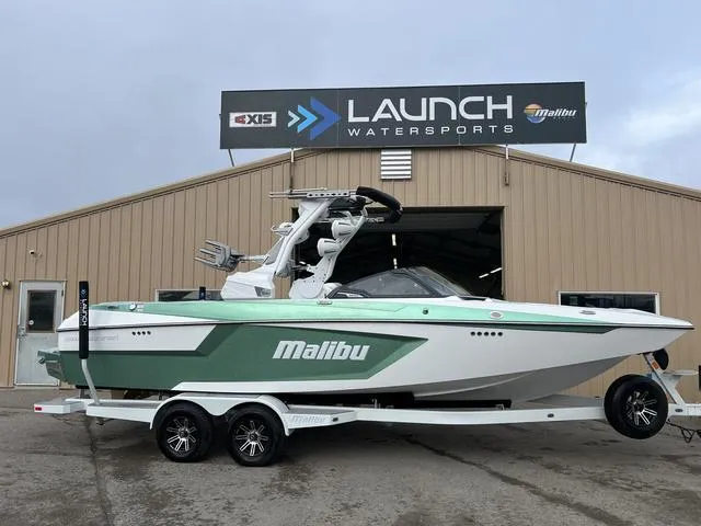 Slide: The Image of 2024 Malibu 24 MXZ boat at Launch Watersports dealership. - 1
