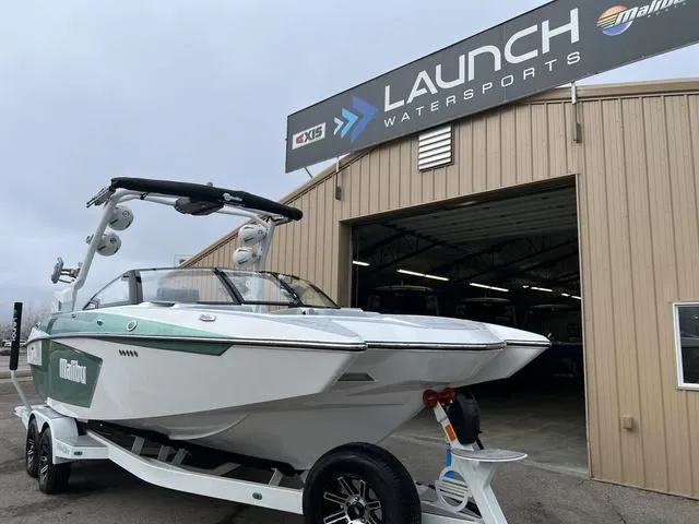 Slide: The Image of 2024 Malibu 24 MXZ boat at Launch Watersports dealership. - 2
