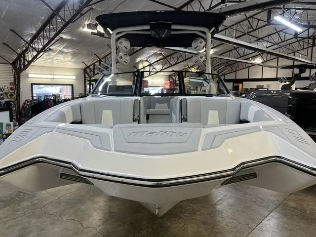 Slide: The Image of 2024 Malibu 24 MXZ boat in showroom, showcasing sleek design and spacious interior. - 3
