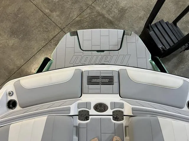 Slide: The Image of 2024 Malibu 24 MXZ boat interior, featuring sleek gray seating and deck design. - 5