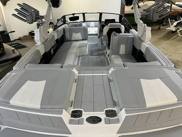 Slide: The Image of 2024 Malibu 24 MXZ boat interior with gray and white seating, spacious layout. - 6