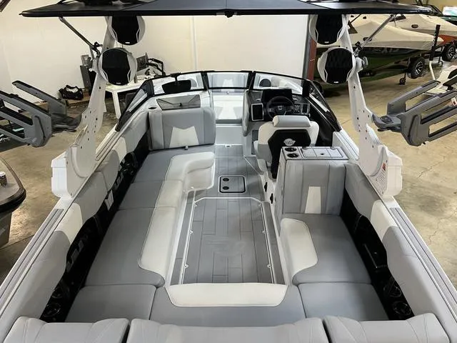 Slide: The Image of 2024 Malibu 24 MXZ boat interior with spacious seating and modern design. - 8