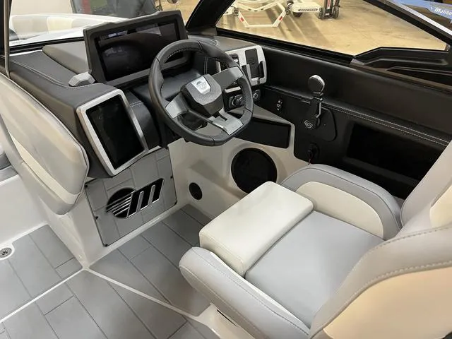 Slide: The Image of 2024 Malibu 24 MXZ boat interior with modern dashboard and steering wheel. - 9