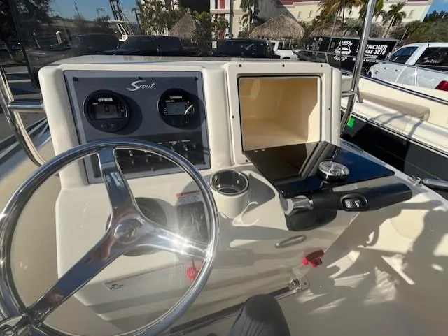 Slide: The Image of 2024 Scout 175 Sportfish boat dashboard with steering wheel and instrument panel. - 10