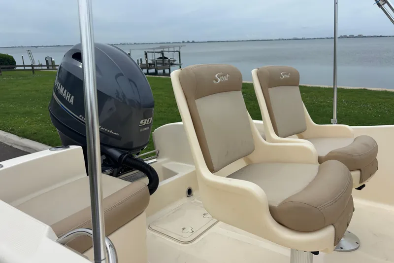 Slide: The Image of 2024 Scout 175 Sportfish boat with Yamaha engine, featuring comfortable seating by the water. - 13