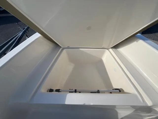 Slide: The Image of 2024 Scout 175 Sportfish storage compartment with open lid. - 15