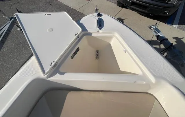 Slide: The Image of 2024 Scout 175 Sportfish boat with open storage compartment. - 16