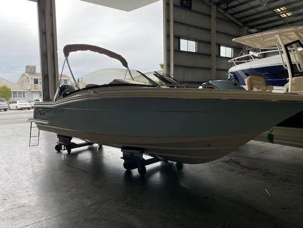 Slide: The Image of 2024 Scout 215 Dorado boat in a warehouse, side view. - 3