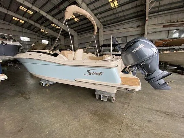 Slide: The Image of 2024 Scout 215 Dorado boat in a warehouse with Yamaha outboard motor. - 5