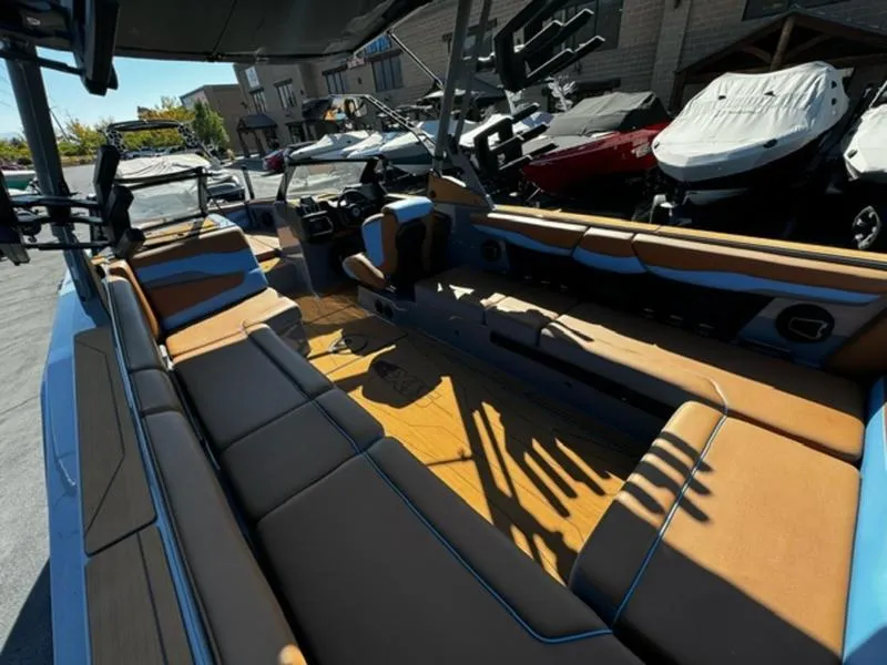 Slide: The Image of 2024 Axis T250 boat interior with tan and blue seating, showcasing spacious design and modern features. - 11