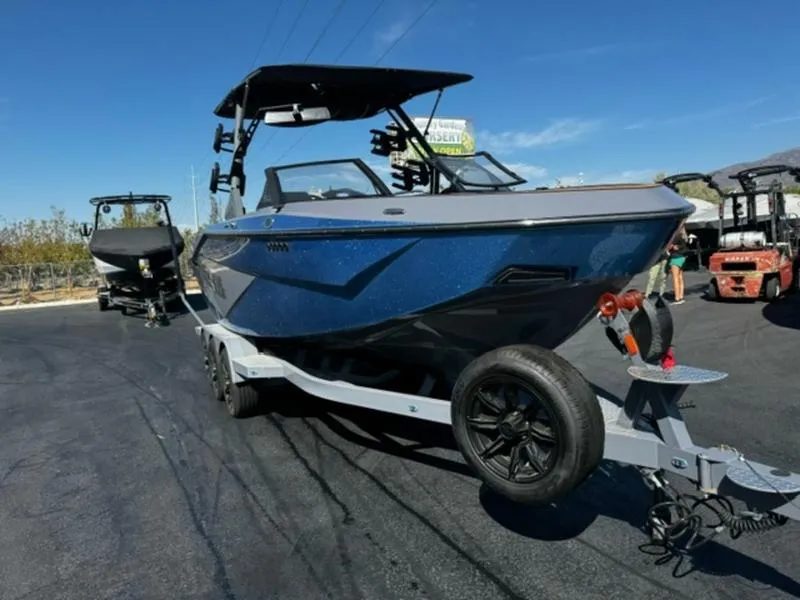 Slide: The Image of 2024 Axis T250 boat on trailer, parked outdoors under clear blue sky. - 4