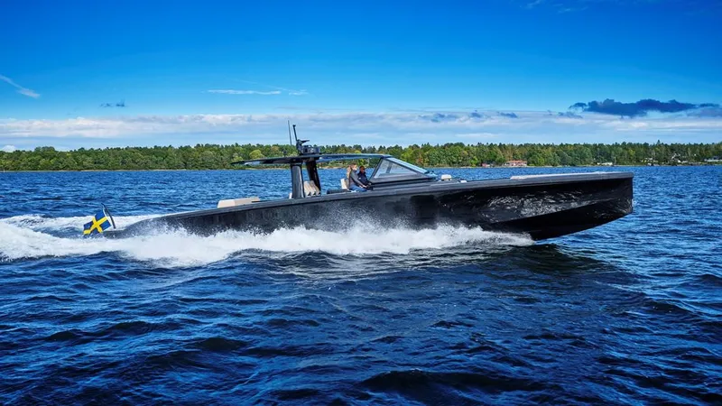 Slide: The Image of 2024 Windy SRL/SR60 boat cruising on a lake with a forested shoreline. - 0