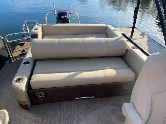 Slide: The Image of 2021 Manitou Oasis 25 SL VP Tritoon rear seating area with beige upholstery. - 10