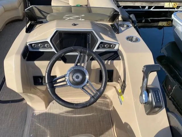 Slide: The Image of 2021 Manitou Oasis 25 SL VP Tritoon steering console with modern controls and dashboard. - 5