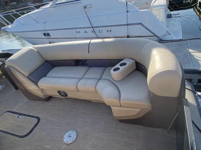 Slide: The Image of 2021 Manitou Oasis 25 SL VP Tritoon with beige seating and cup holders. - 8