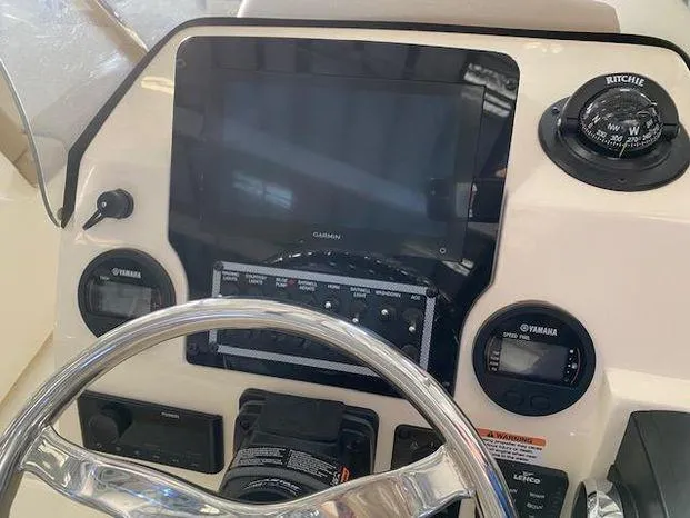 Slide: The Image of 2024 Scout 195 Sport Dorado boat dashboard with Garmin display and Yamaha controls. - 5