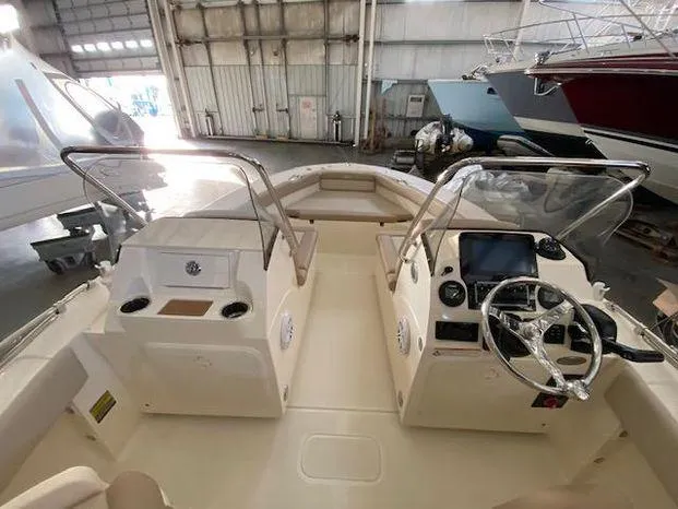 Slide: The Image of 2024 Scout 195 Sport Dorado boat interior with dual consoles and steering wheel. - 8