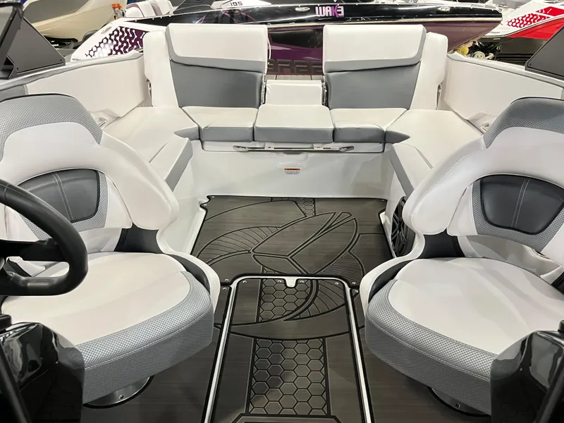 Slide: The Image of 2024 Scarab 215 Wake ID boat interior with white and gray seating. - 5