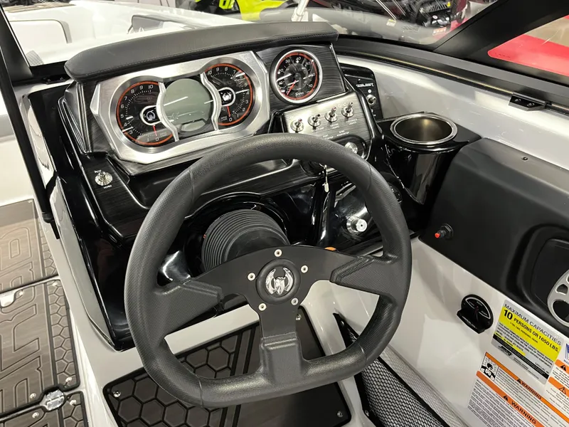 Slide: The Image of 2024 Scarab 215 Wake ID boat dashboard with steering wheel and control panel. - 6