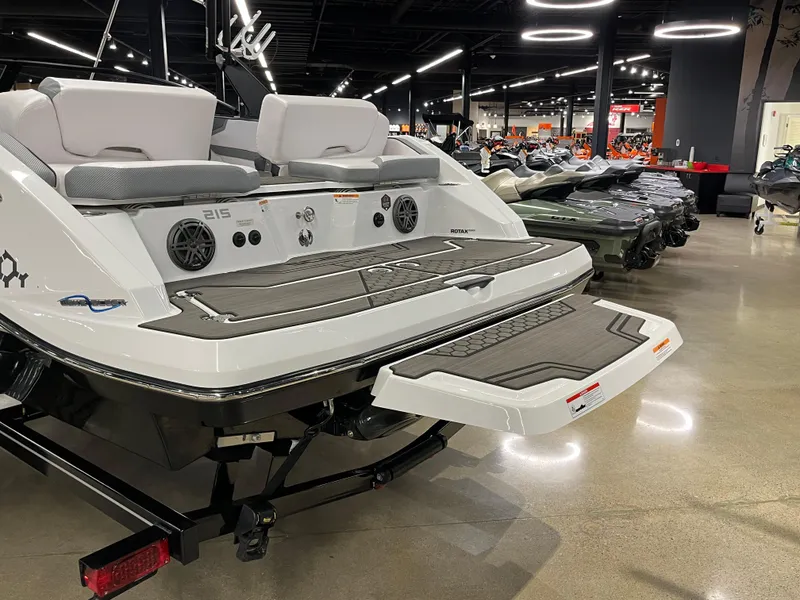 Slide: The Image of 2024 Scarab 215 Wake ID boat rear view in showroom with swim platform. - 7