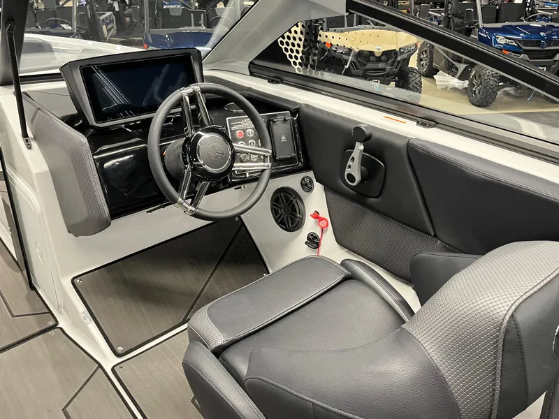 Slide: The Image of 2024 Scarab 235 Wake ID boat interior with modern dashboard and steering wheel. - 6