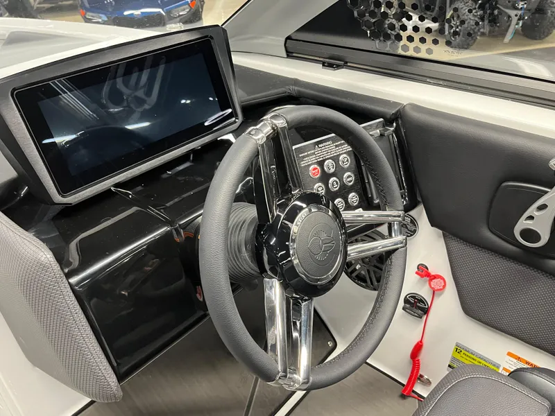Slide: The Image of 2024 Scarab 235 Wake ID boat dashboard with touchscreen display and steering wheel. - 8