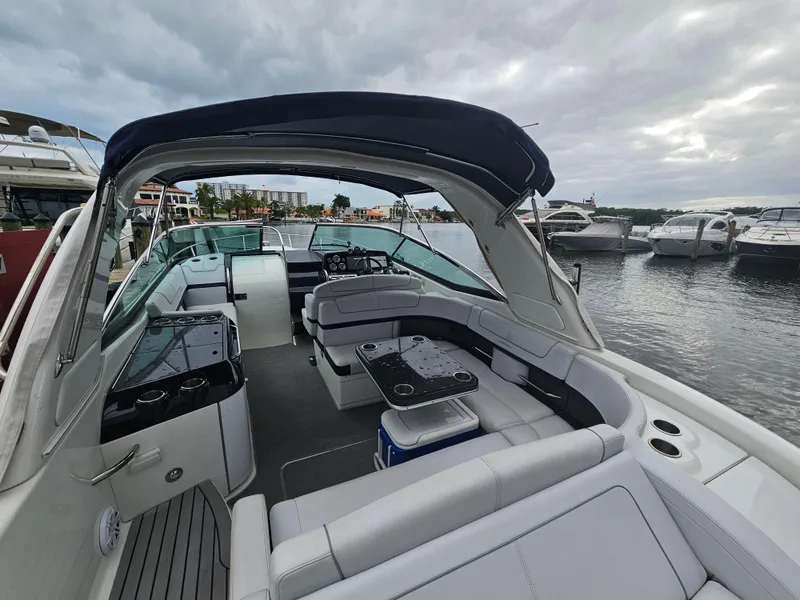 Slide: The Image of 2018 Formula 350 Sun Sport boat with spacious seating docked at marina. - 13