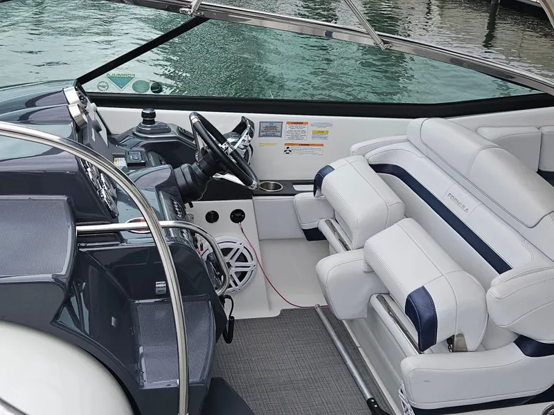 Slide: The Image of 2018 Formula 350 Sun Sport boat interior with steering wheel and seating. - 18