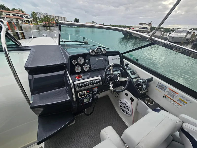 Slide: The Image of 2018 Formula 350 Sun Sport boat cockpit with modern controls and waterfront view. - 19