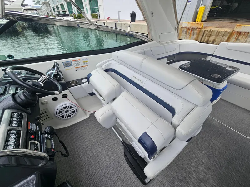 Slide: The Image of 2018 Formula 350 Sun Sport boat interior with plush seating and modern dashboard. - 20