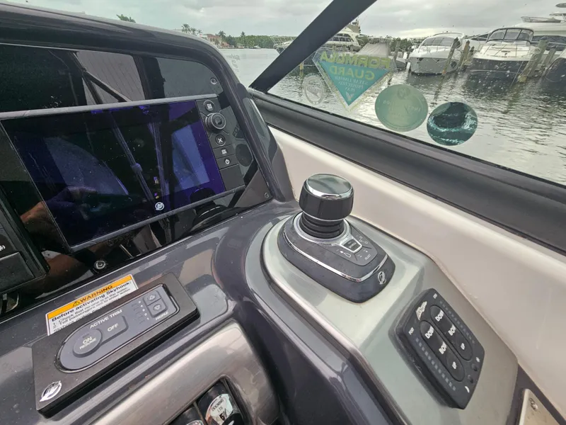 Slide: The Image of 2018 Formula 350 Sun Sport helm with joystick control and navigation display. - 23