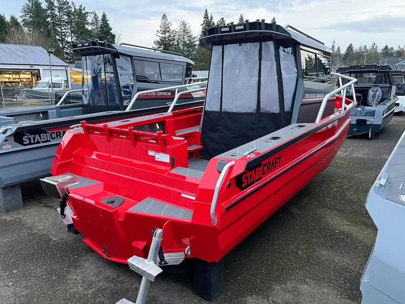 Slide: The Image of 2024 Stabicraft 2250 Alpha Ultra Centrecab boat in red, parked outdoors. - 10