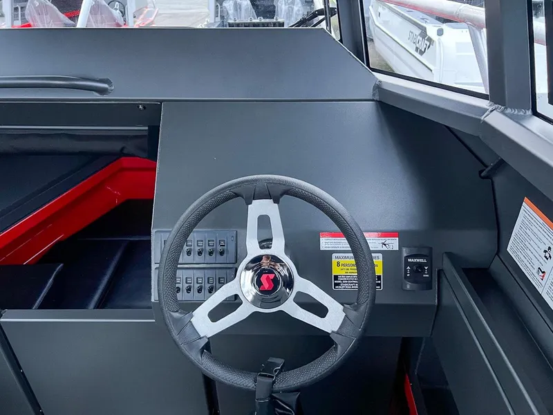 Slide: The Image of 2024 Stabicraft 2250 Alpha Ultra Centrecab helm with steering wheel and control panel. - 13