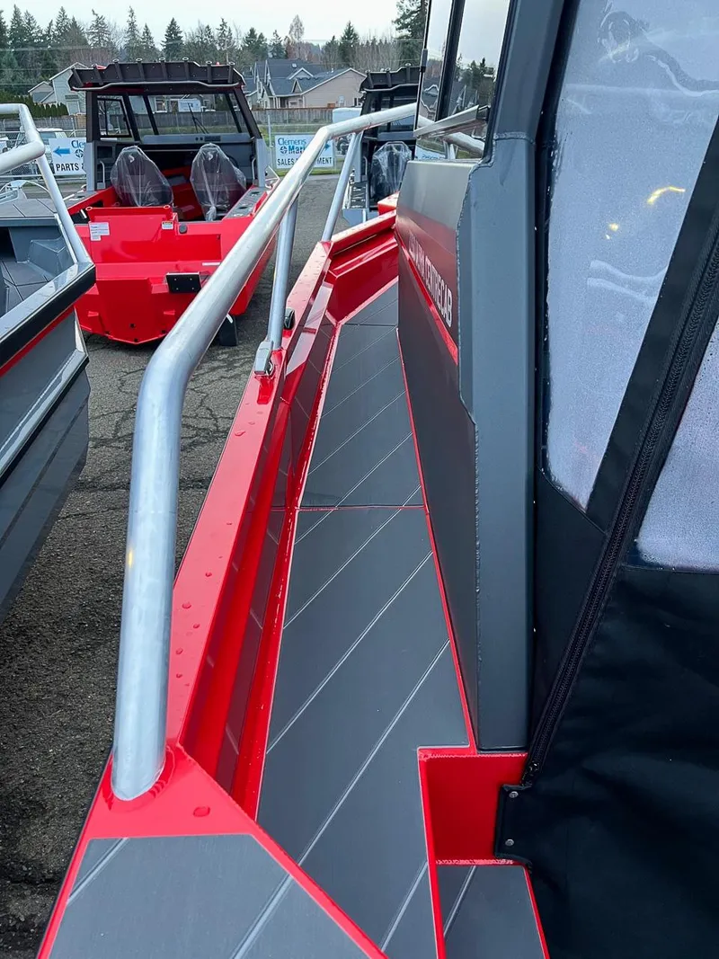Slide: The Image of 2024 Stabicraft 2250 Alpha Ultra Centrecab boat, side view with red and gray detailing. - 23