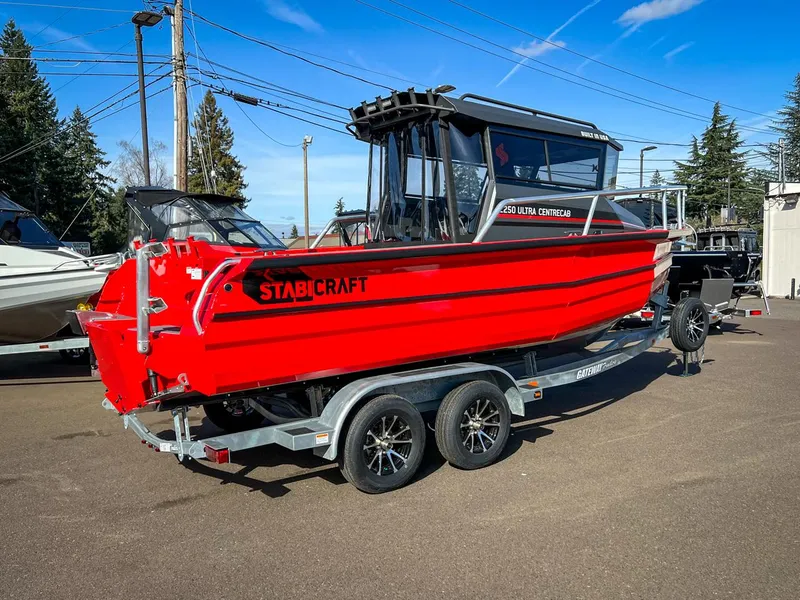 Slide: The Image of 2024 Stabicraft 2250 Alpha Ultra Centrecab boat on a trailer in a parking lot. - 3