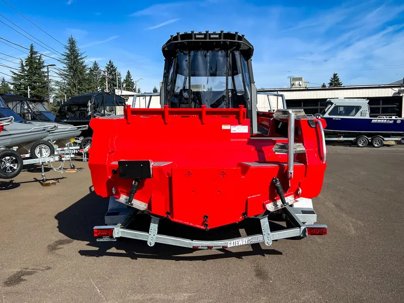 Slide: The Image of 2024 Stabicraft 2250 Alpha Ultra Centrecab in red, rear view at a boat dealership. - 4