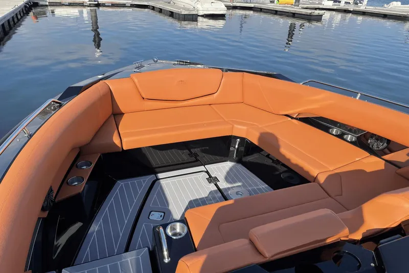 Slide: The Image of 2021 Cruisers Yachts 338 CX with orange seating at a marina. - 11