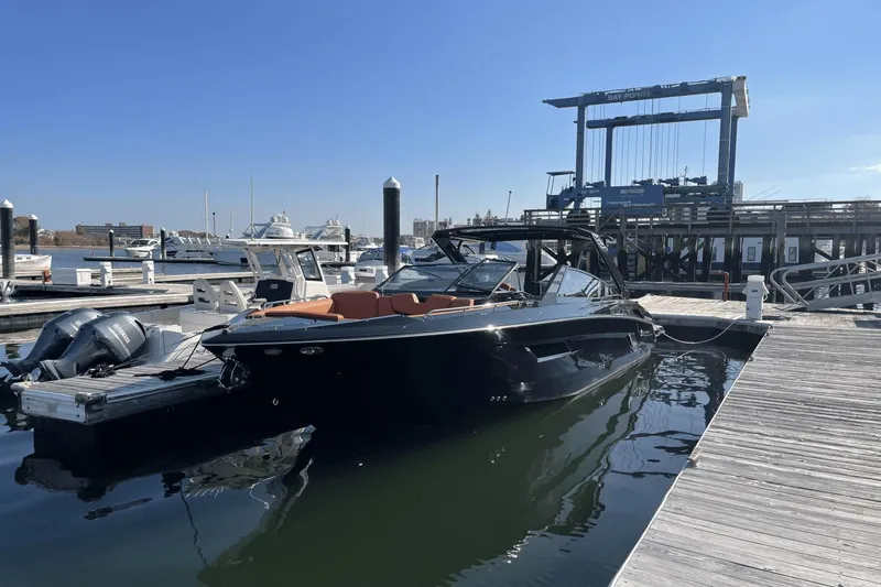 Slide: The Image of 2021 Cruisers Yachts 338 CX docked at a marina on a sunny day. - 2