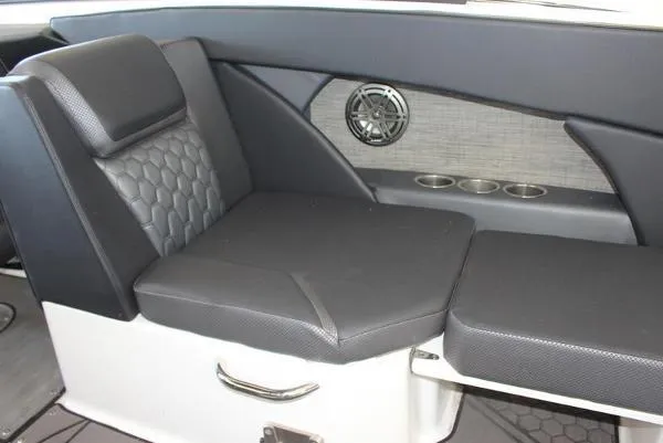 Slide: The Image of 2023 Scarab 255 ID boat interior seating with black upholstery and cup holders. - 10